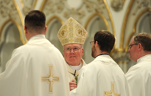 Bishop Richard Malone is all smiles as he blesses the new priests on the altar during the Ordination Mass at St. Joseph Cathedral. (Dan Cappellazzo/Staff Photographer)